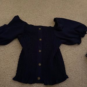 Blue tight t-shirt with flared sleeves.